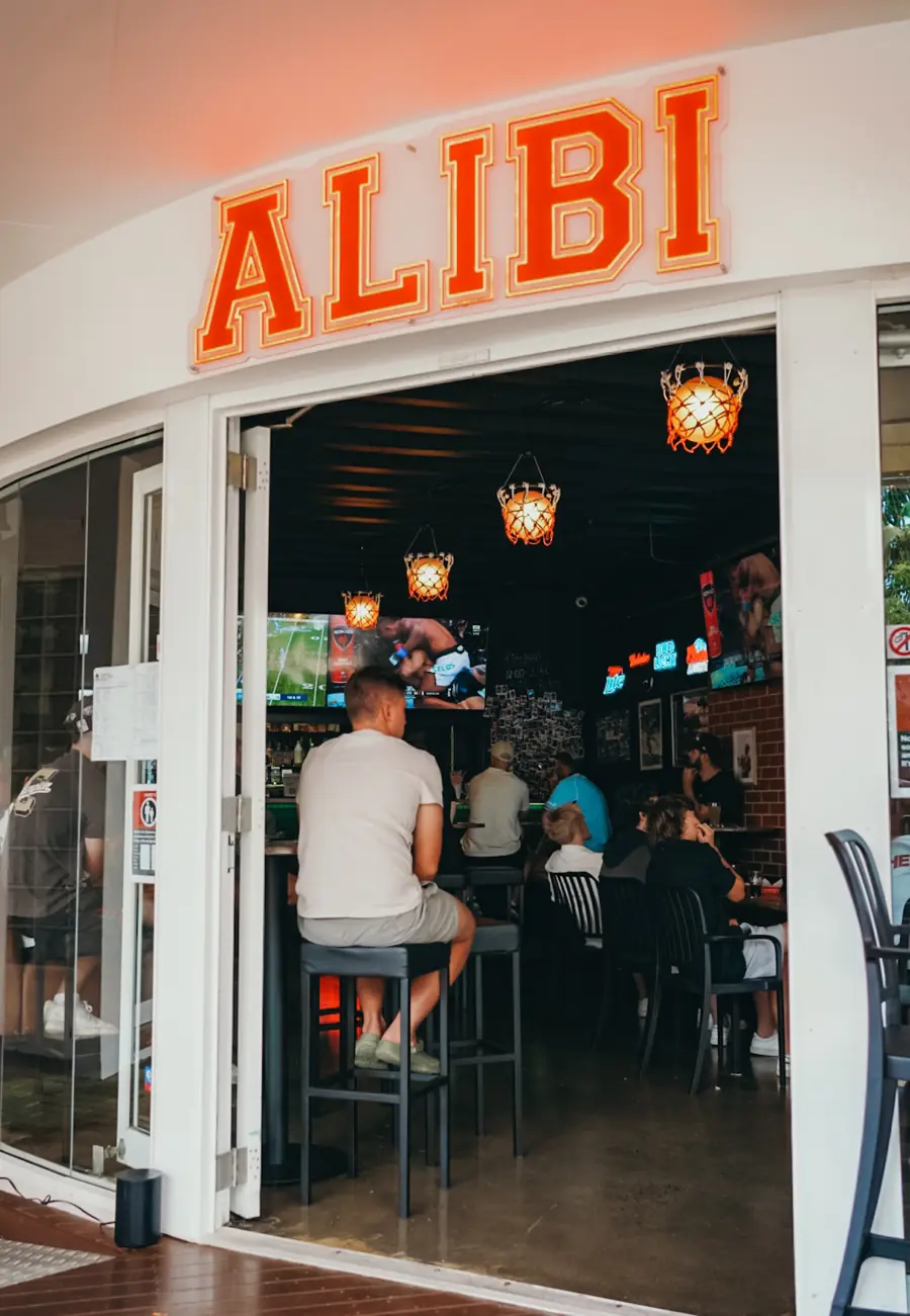 The glowing ALIBI neon sign over the entrance on Owen Street